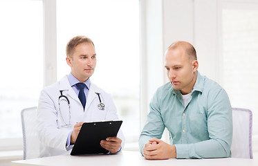 Image showing doctor with clipboard and patient in hospital