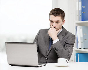 Image showing busy businessman with laptop and coffee