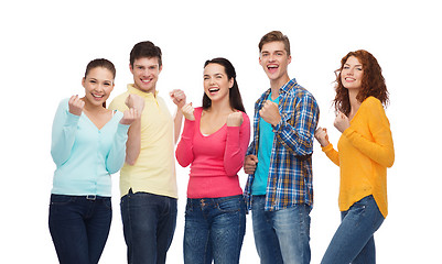 Image showing group of smiling teenagers showing triumph gesture