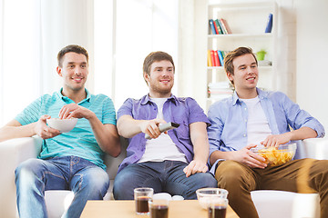 Image showing happy male friends watching tv at home