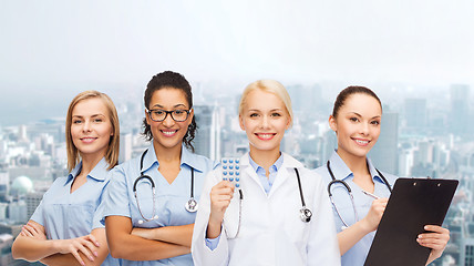 Image showing smiling female doctor and nurses with stethoscope