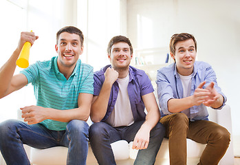 Image showing happy male friends with vuvuzela