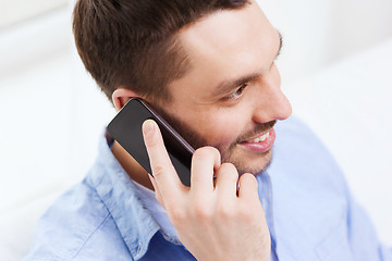 Image showing close up of smiling businessman with smartphone