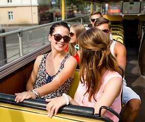 Image showing group of smiling friends traveling by tour bus