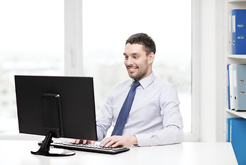 Image showing smiling businessman or student with computer