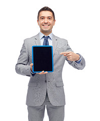 Image showing happy businessman in suit showing tablet pc screen