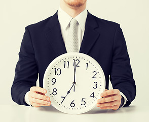 Image showing man with wall clock