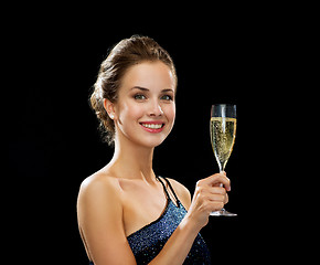 Image showing smiling woman holding glass of sparkling wine