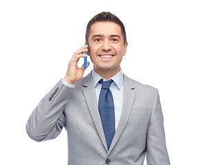 Image showing happy businessman calling on smartphone