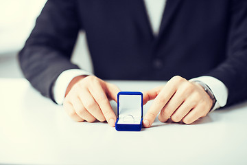 Image showing man with gift box and wedding ring