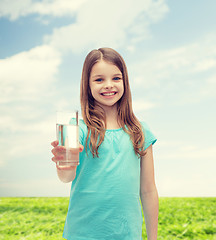 Image showing smiling little girl giving glass of water