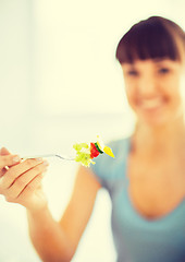 Image showing woman hand holding fork with vegetables