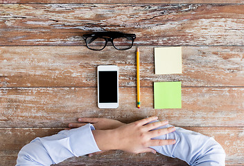 Image showing close up of hands with office stuff on table