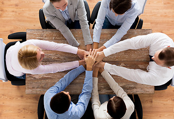 Image showing close up of business team with hands on top