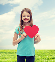 Image showing smiling little girl with red heart