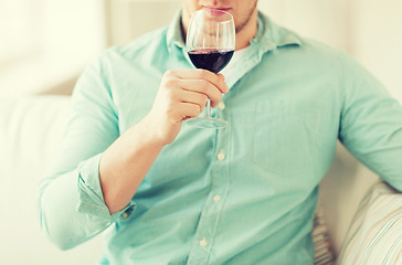 Image showing close up of man drinking wine at home