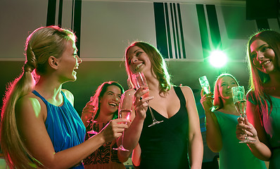 Image showing young women with glasses of champagne in club