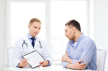 Image showing doctor with clipboard and patient in hospital