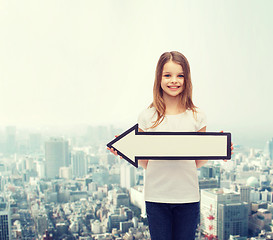 Image showing smiling girl with blank arrow pointing left