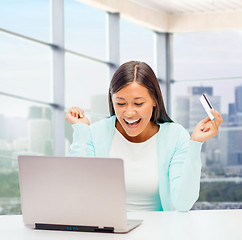 Image showing happy businesswoman with laptop and credit card