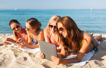 Image showing group of smiling young women with tablets on beach