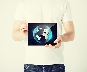 Image showing man hands holding tablet pc with sign of globe