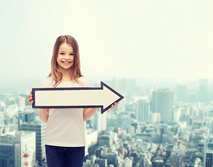 Image showing smiling girl with blank arrow pointing right