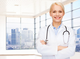 Image showing smiling young female doctor in white coat