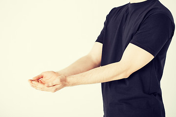 Image showing mans hands showing something