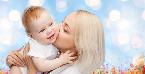 Image showing happy mother with baby over natural background