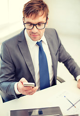 Image showing businessman working with laptop and smartphone