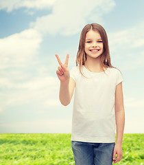 Image showing little girl in white t-shirt showing peace gesture