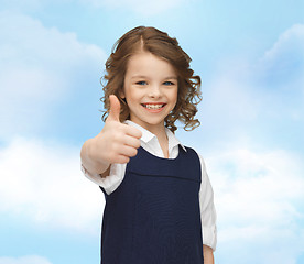 Image showing happy little school girl showing thumbs up