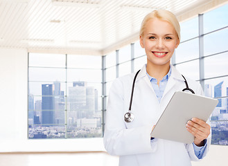 Image showing smiling young female doctor in white coat