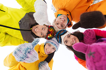 Image showing happy friends in winter clothes outdoors