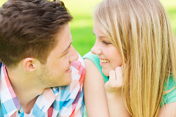 Image showing smiling couple looking at each other in park