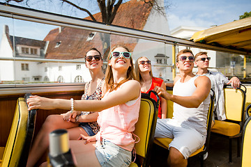 Image showing group of smiling friends traveling by tour bus