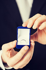 Image showing man with gift box and wedding ring