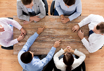 Image showing close up of business team sitting at table