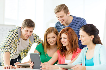 Image showing smiling students with tablet pc at school