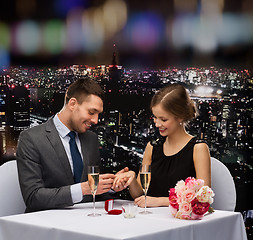 Image showing man proposing to his girlfriend at restaurant