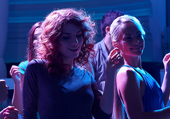 Image showing group of happy friends dancing in night club