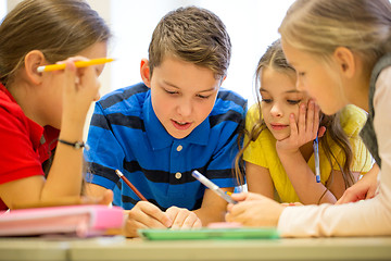 Image showing group of students talking and writing at school