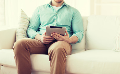 Image showing close up of man with tablet pc computer at home