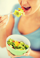 Image showing woman eating salad with vegetables