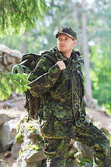 Image showing young soldier with backpack in forest