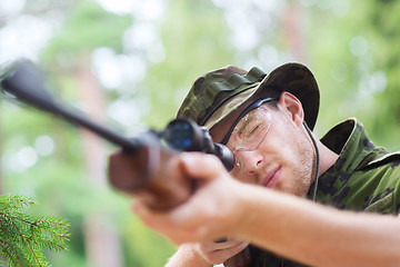 Image showing young soldier or hunter with gun in forest