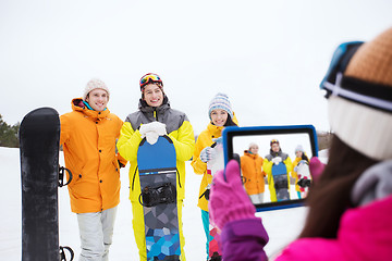 Image showing happy friends with snowboards and tablet pc