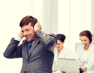 Image showing stressed buisnessman or teacher closing ears