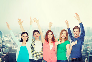 Image showing group of smiling students waving hands